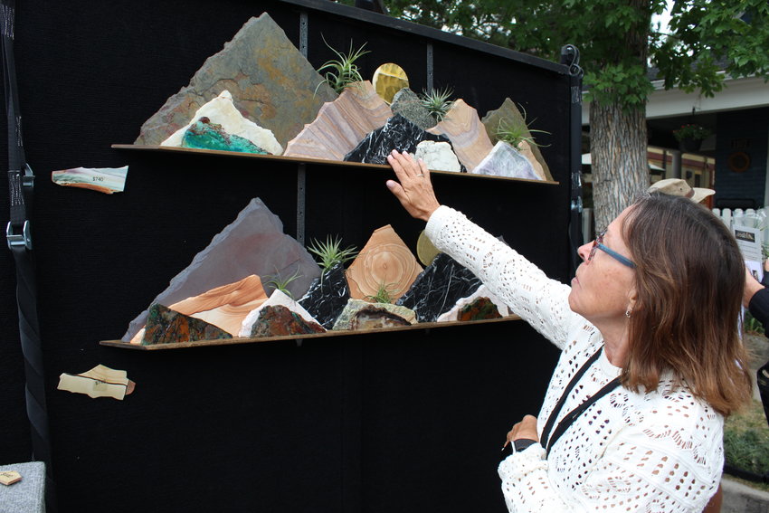 The Locke family of Tucson-based Mountain Sculpture Studios detail the process for making stone sculptures at the Golden Fine Arts Festival Aug. 20 in downtown Golden.